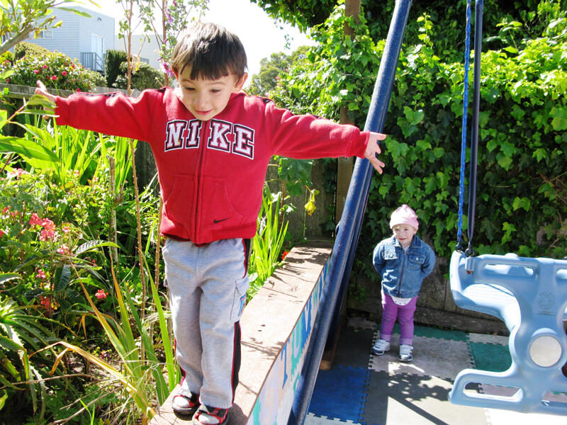 Untitled Children smiling on the outdoor swings