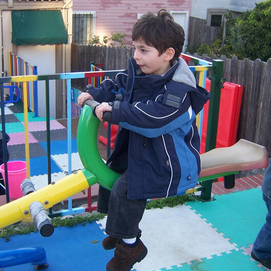 Untitled Child playing on outdoor playground equipment