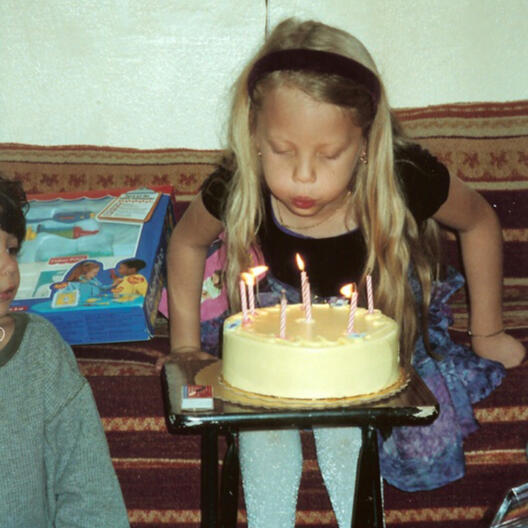 Untitled Child blowing out birthday candles