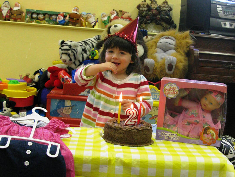 Untitled Child celebrating a second birthday with cake