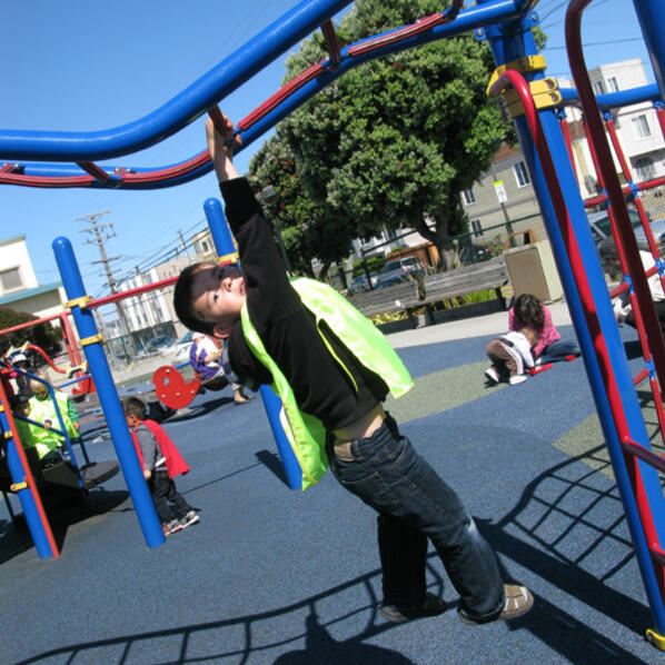 Untitled Child climbing playground equipment at a Sunset District playground