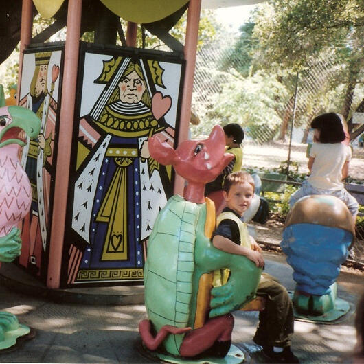Untitled Child riding a dragon carousel figure