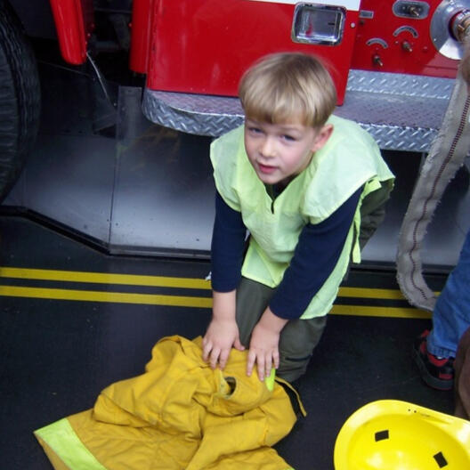 Untitled Child learning about firefighter gear
