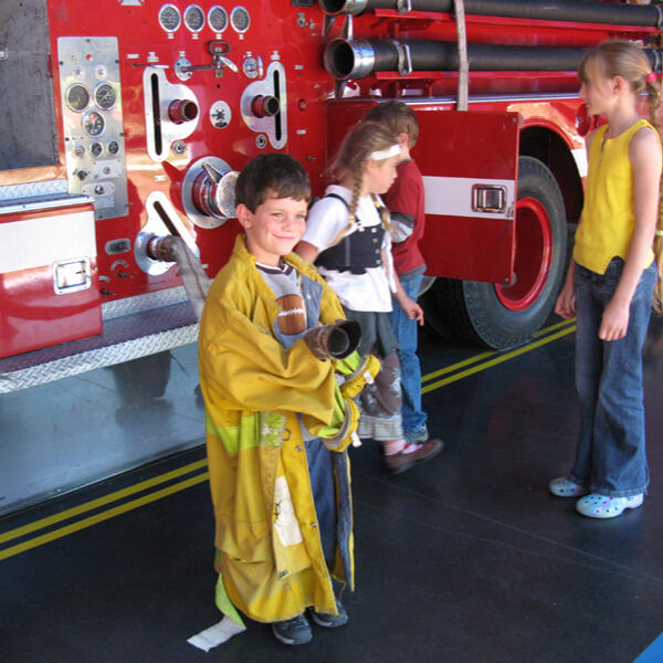 Untitled Children visiting a fire truck on a field trip