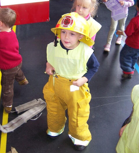 Untitled Child learning about firefighter gear