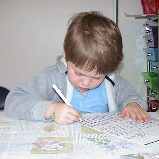 Untitled Child practicing writing at the table