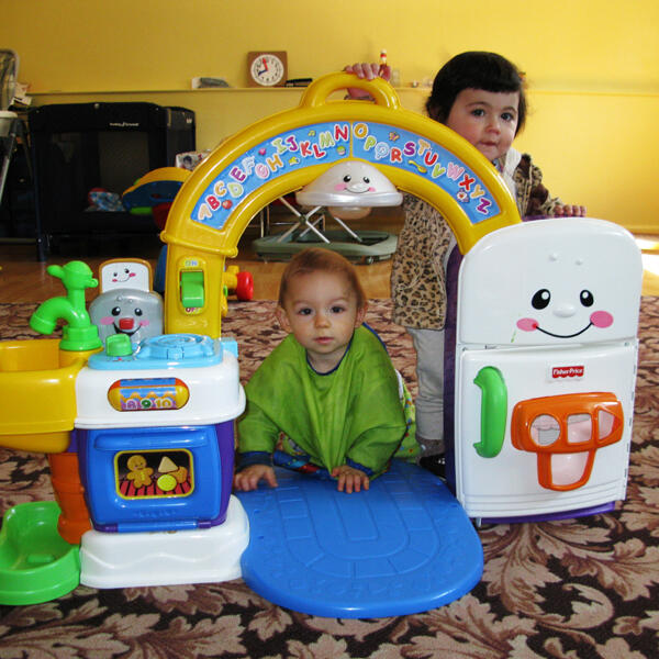Untitled Infants playing with an alphabet activity toy